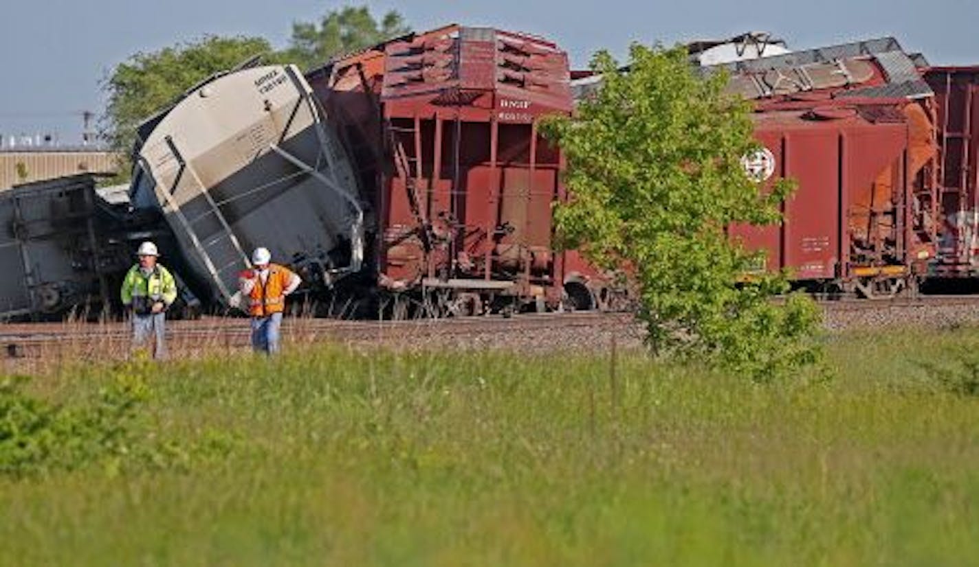 Crews made their way around a BNSF train derailment involving 16 empty freight cars, Friday, June 13, 2014 in Ramsey.