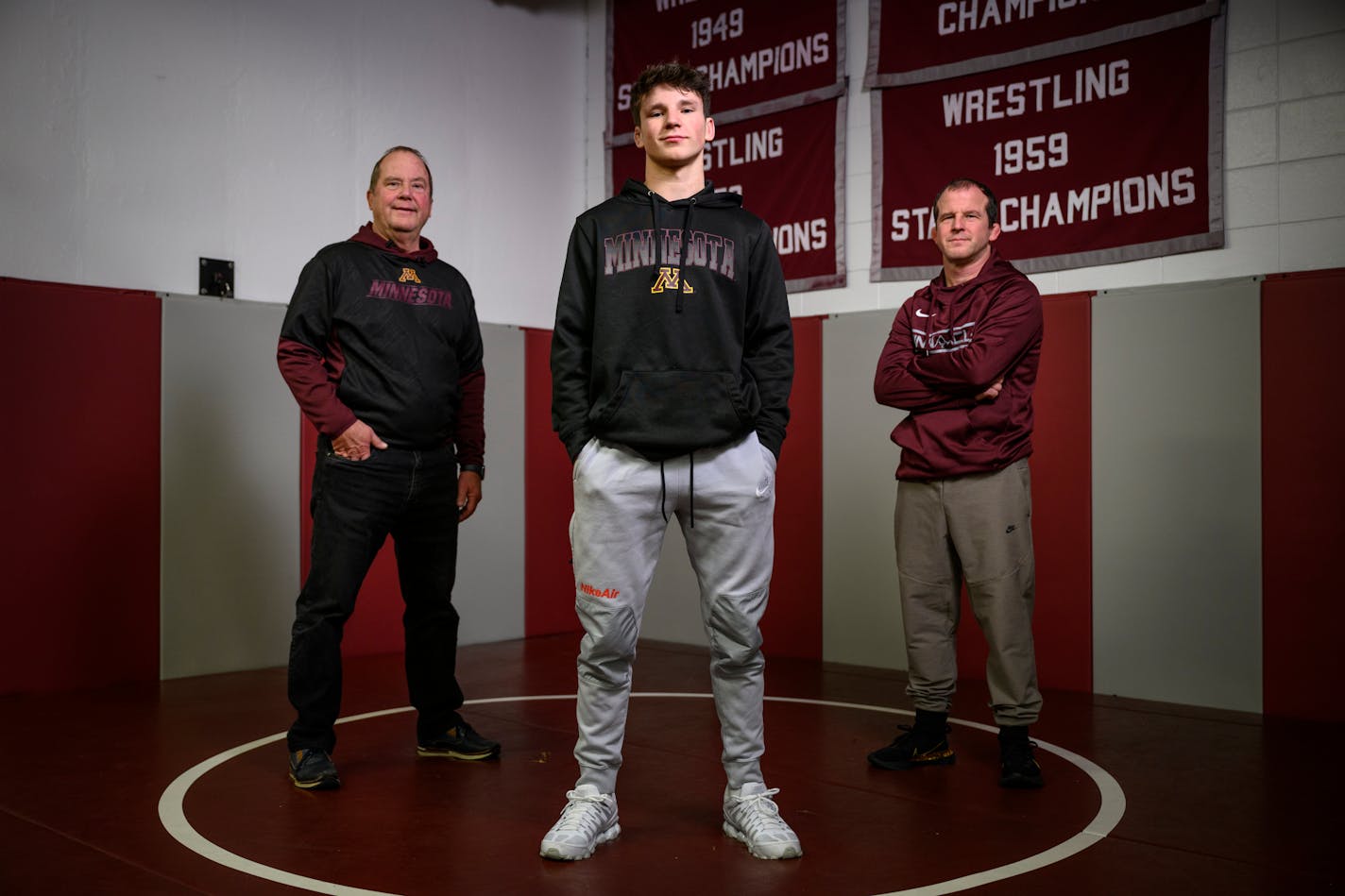 Junior Eli Paulson stands with his grandfather Doug, right, and father Brandon Monday, Jan. 17, 2022 at Anoka High School. ] AARON LAVINSKY • aaron.lavinsky@startribune.com