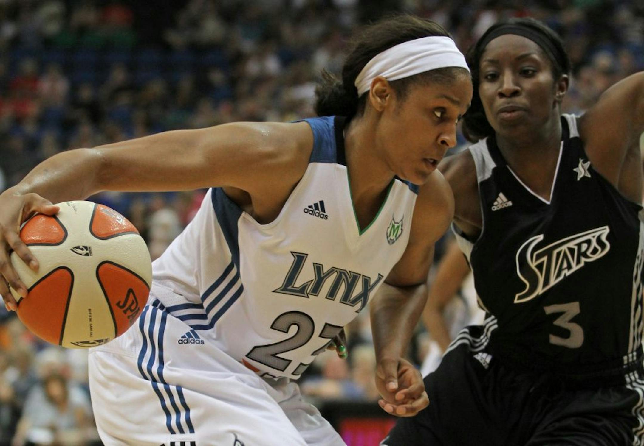 Minnesota Lynx Maya Moore drove agains San Antonio's Scholanda Robinson in 2nd half action at the Target Center, 8/26/2011.