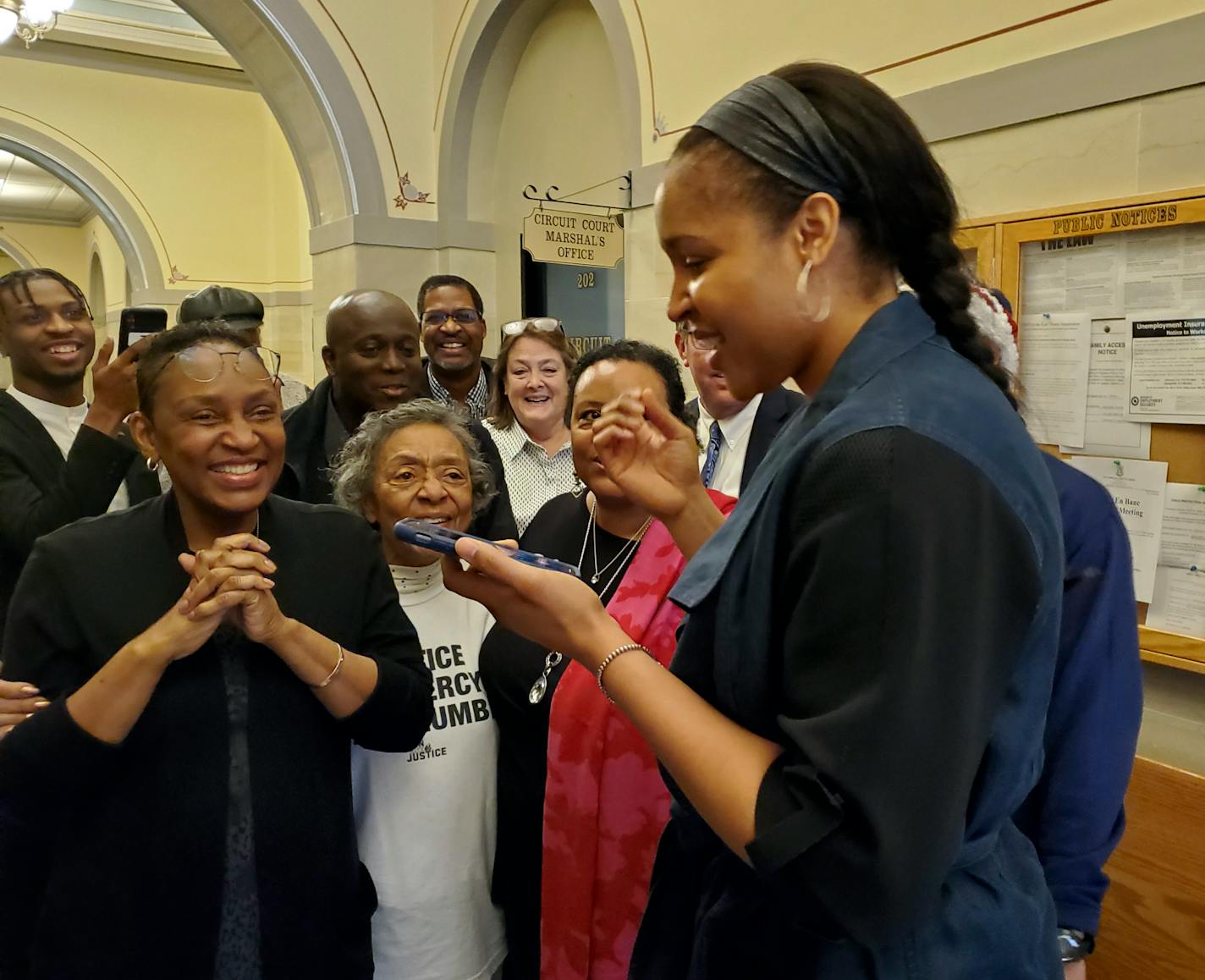 Jefferson City, Mo., native and WNBA star Maya Moore, right, calls Jonathan Irons as supporters react Monday, March 9, 2020, in Jefferson City after Cole County Judge Dan Green overturned Irons' convictions in a 1997 burglary and assault case. Moore, a family friend, had supported Irons, sharing his story on a national basis. (Jeff Haldiman/The Jefferson City News-Tribune via AP)