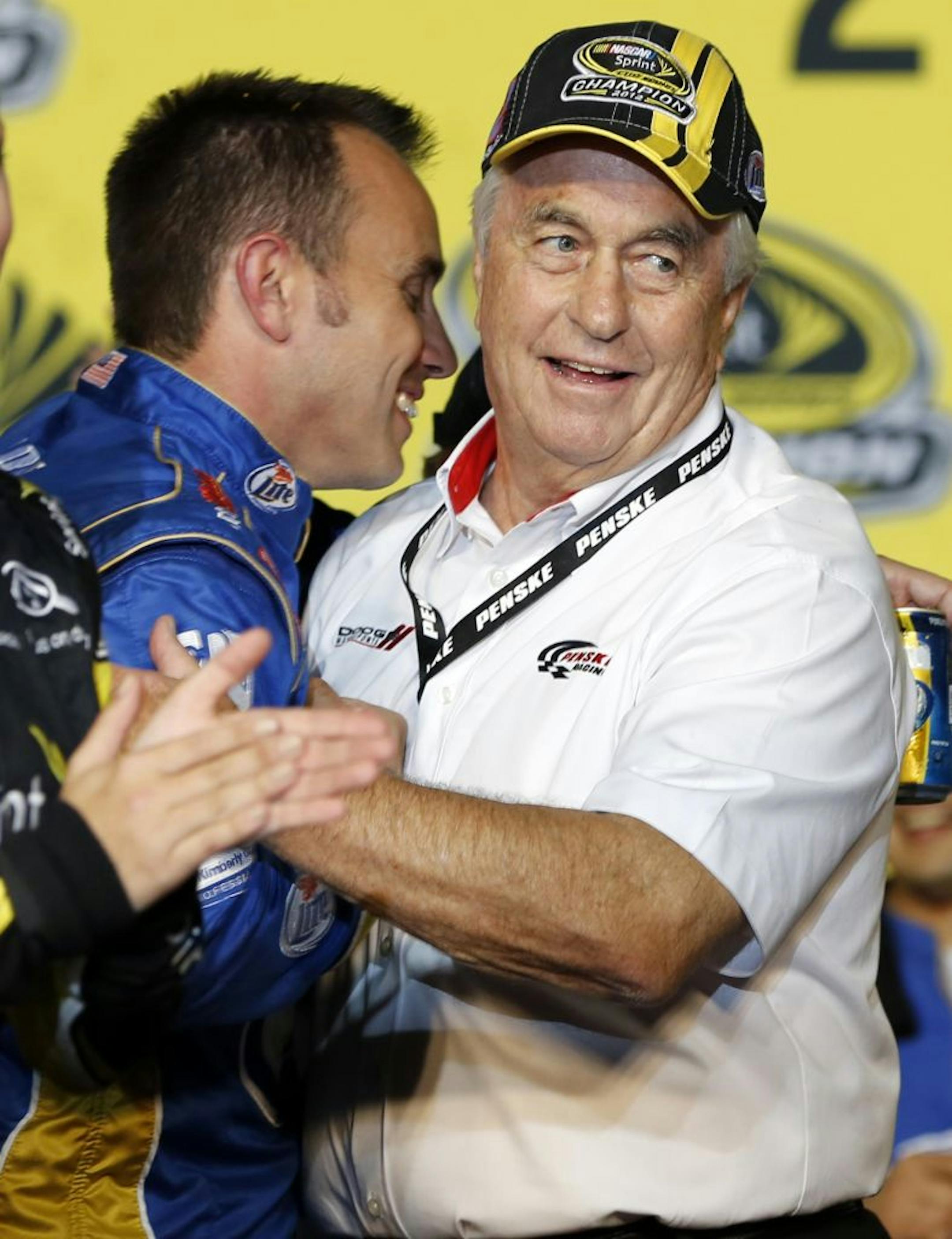 Crew chief Paul Wolfe, left, congratulates owner Roger Penske after Brad Keselowski won the NASCAR Sprint Cup Series championship.