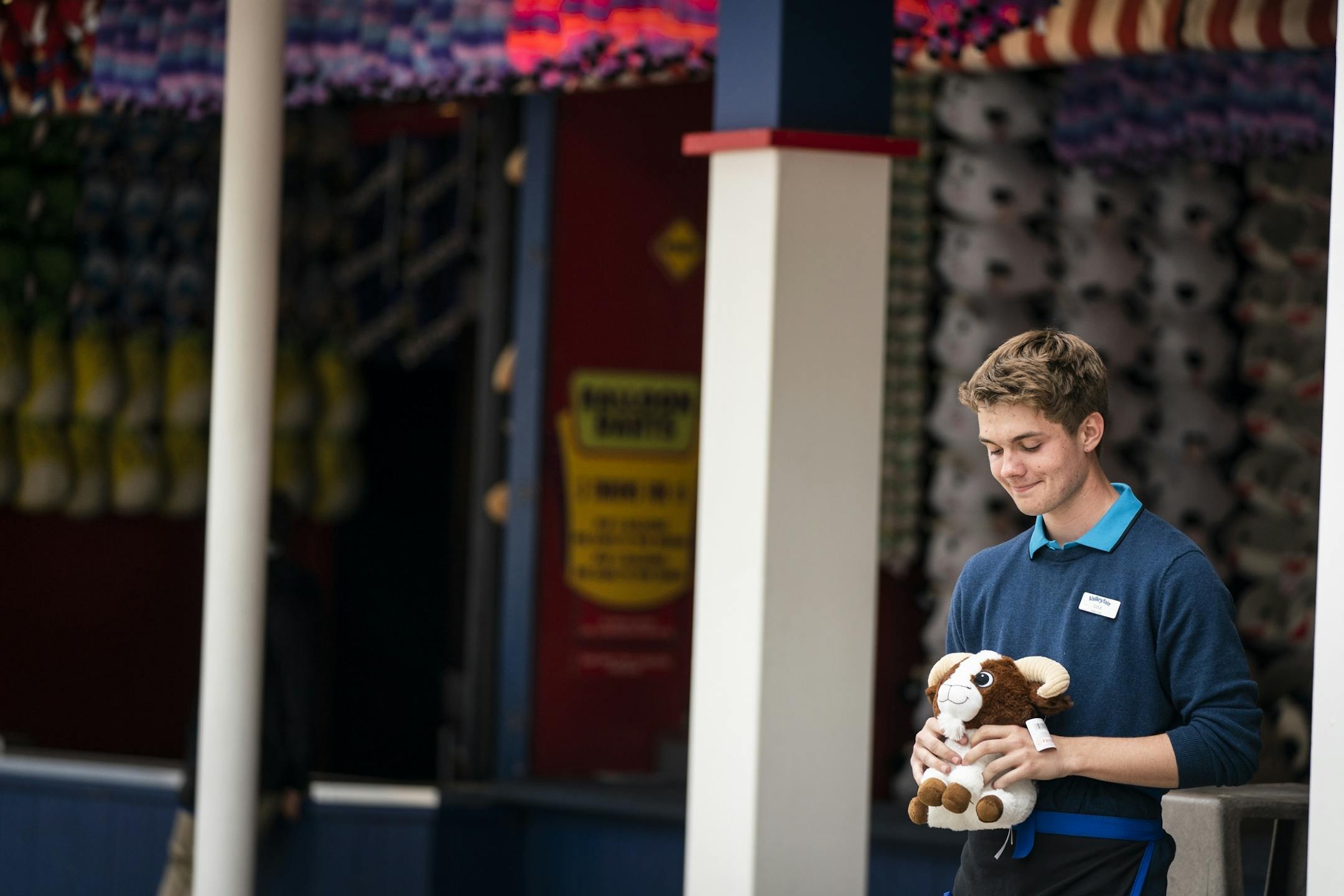 Cole Boelter, 19, of Prior Lake, waits for customers while working at Hang Time in the games area of ValleyFair.