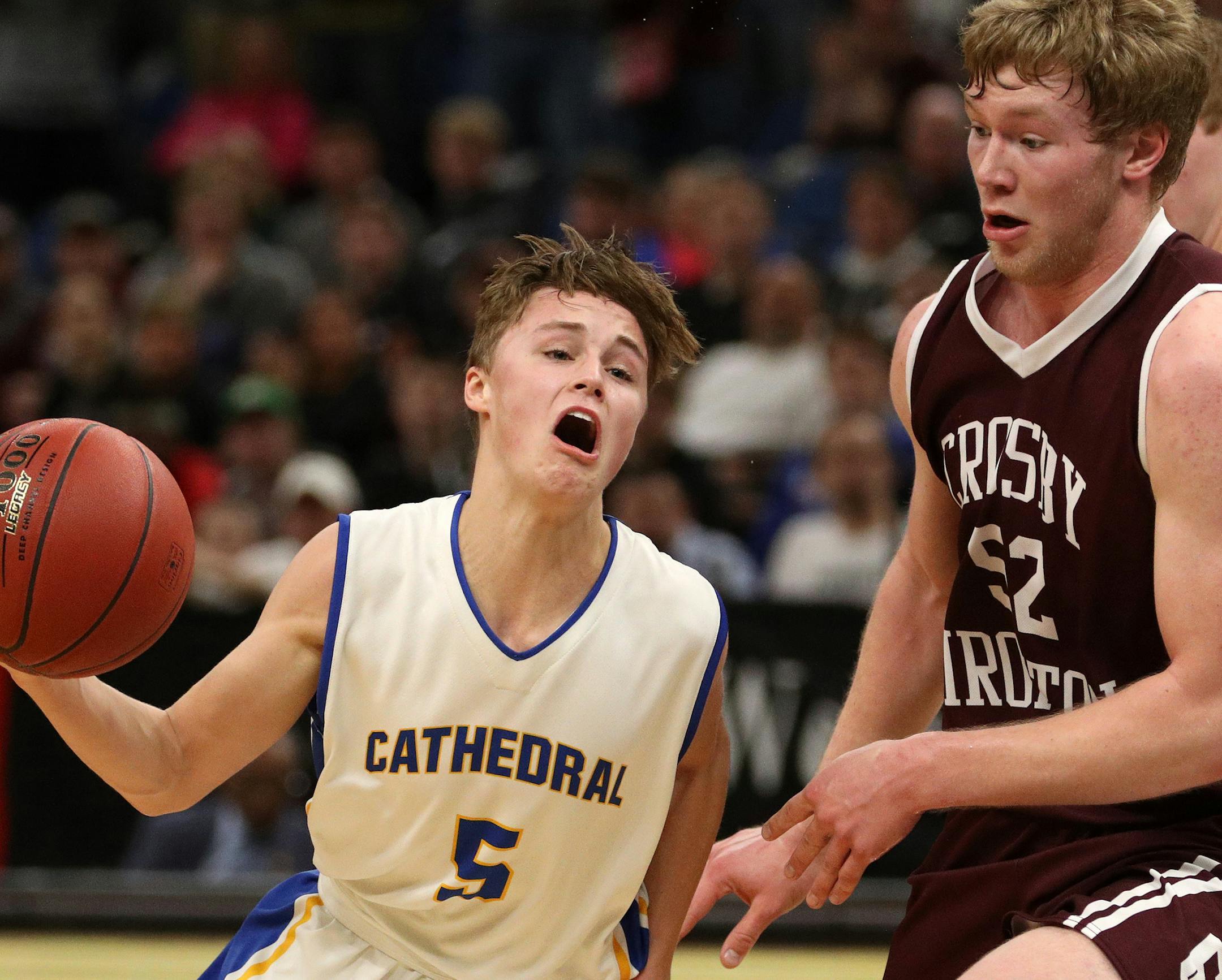St. Cloud Cathedral High School guard Jackson Baustian Jangula (5) dribbled the ball around Crosby-Ironton High School center Noah Gindorff (52) as he drove to the basket in the first half. ] ANTHONY SOUFFLE ï anthony.souffle@startribune.com Players competed during the boys' basketball state tournament Class 2A semifinal games Friday, March 24, 2017 at the Target Center in Minneapolis.