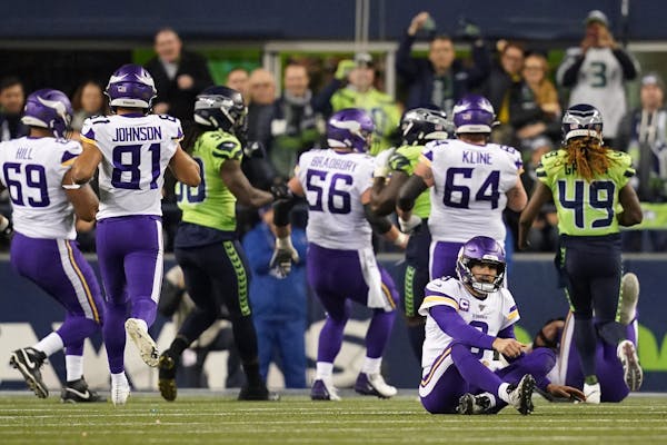 Vikings quarterback Kirk Cousins (8) sat on the field after a fumble in the third quarter.