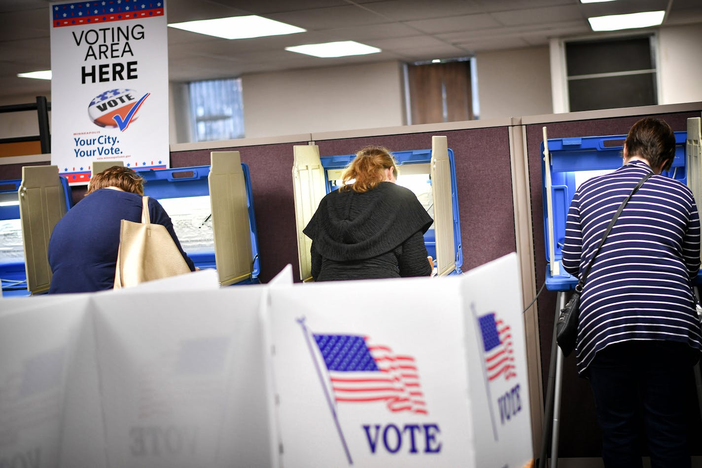 Voters cast their ballots at a voting center in Minneapolis Friday, Sept. 23, 2016. Friday kicked off the state's early voting period, making Minnesota among the first states to open up voting. It's the state's second election with early voting as an option but the first during a presidential contest. (Glen Stubbe/Star Tribune via AP) ORG XMIT: MIN2016093017575455 ORG XMIT: MIN1611071410550018