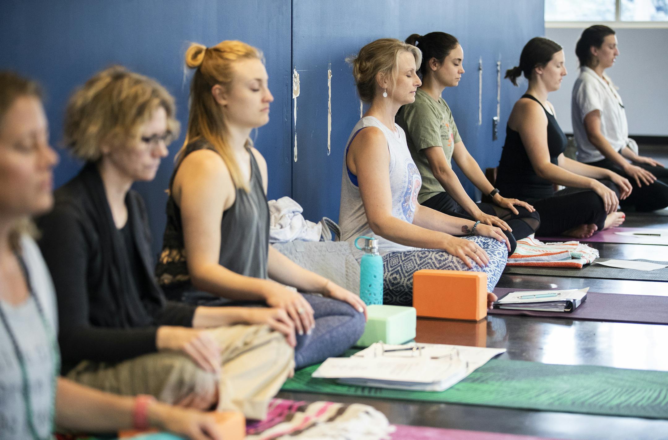 Teacher training students participate in a Yin Yoga elective tech session in the temporary space of The Yoga Retreat Center. ] LEILA NAVIDI ï leila.navidi@startribune.com BACKGROUND INFORMATION: Jennifer Gray of The Yoga Retreat Center talks to students before a Yin elective tech session, part of their 230 hour teacher training, inside their temporary space in St. Louis Park on Tuesday, June 19, 2018. Months after the Yoga Center of Minneapolis collapsed, founder Jennifer Gray is rebuilding
