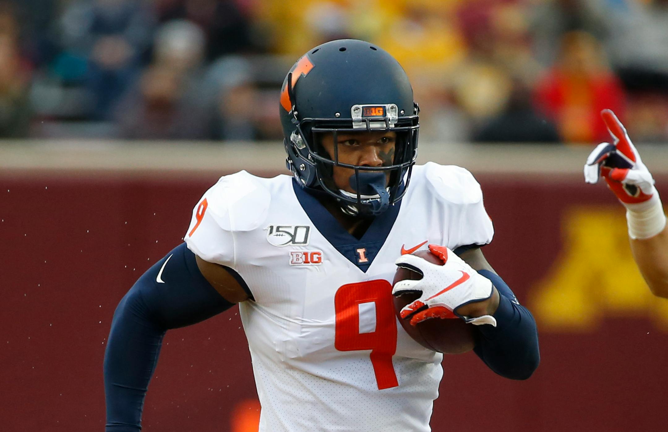 Illinois linebacker Dele Harding (9) returns his interception of a Minnesota pass for a touchdown in the first quarter at an NCAA college football game Saturday, Oct. 5, 2019, in Minneapolis. (AP Photo/Bruce Kluckhohn)