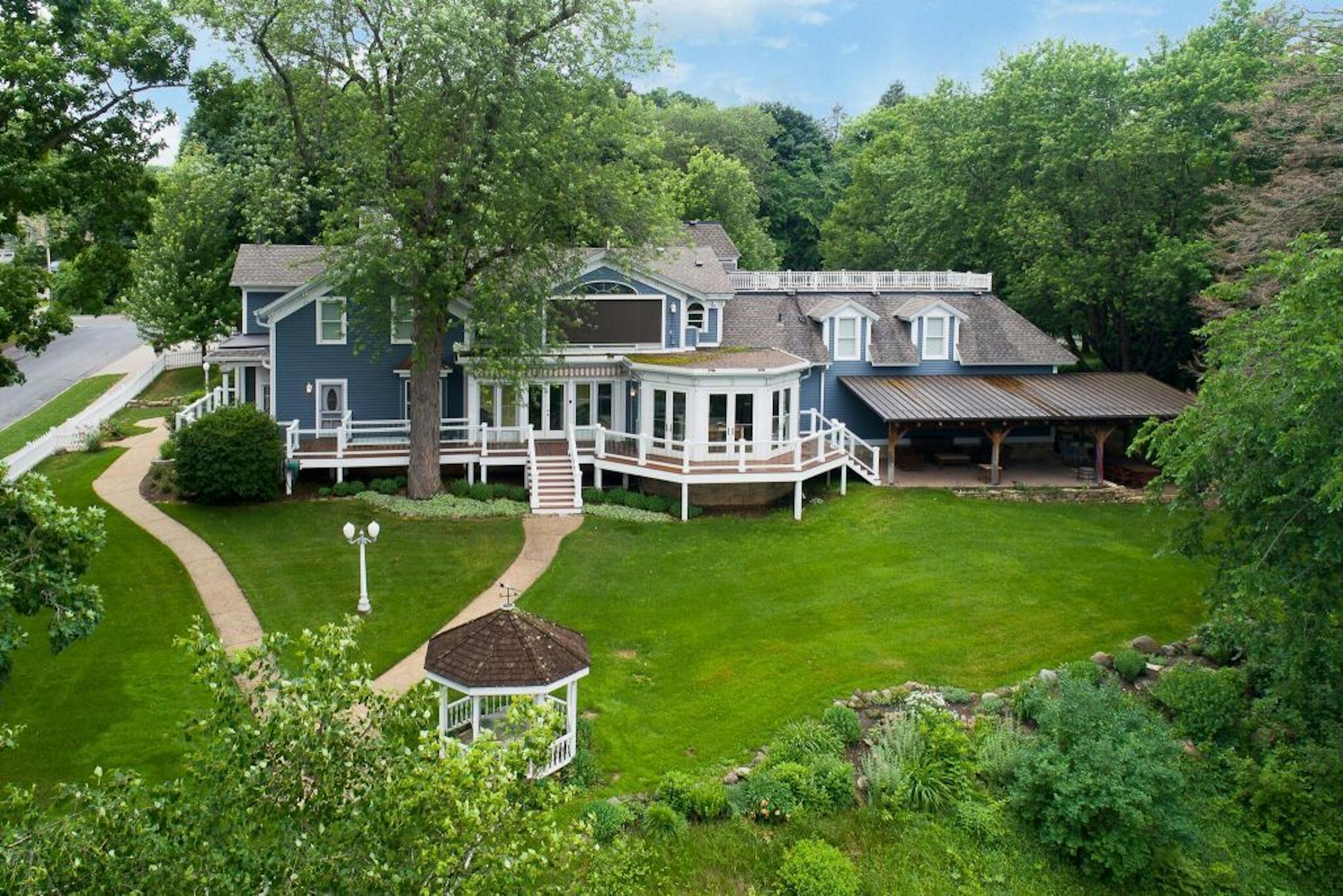 The house is set on 1.7 acres with tiered gardens and a waterfall.