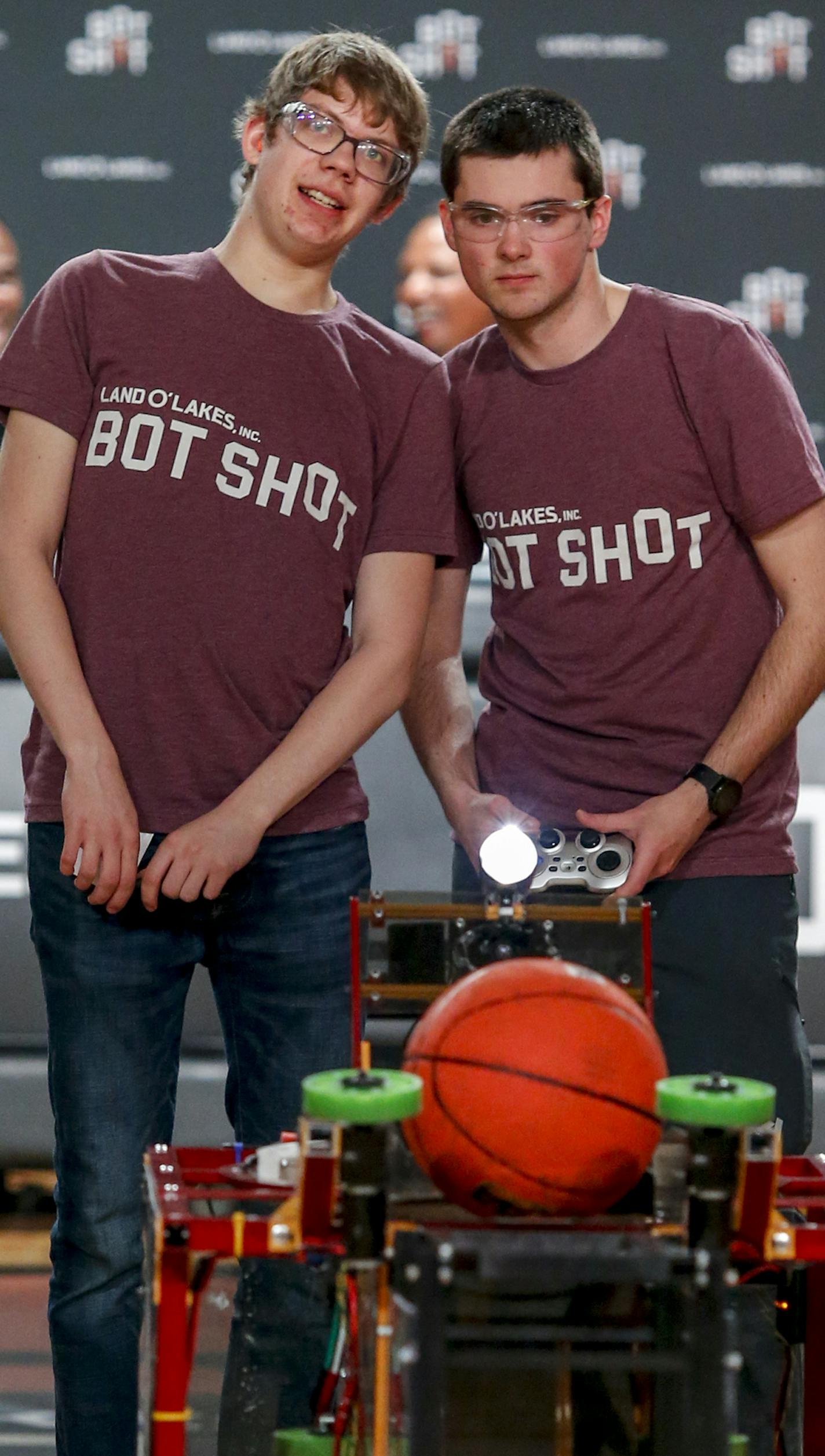 University of Minnesota robotics team members Karl Olson (left) and Jimmy Donadio manuever their hoop-shooting robot for a shot at the Land O'Lakes Bot Shot on Sunday, April 7, 2019. (Bruce Kluckhohn/AP Images for Land O'Lakes, Inc.)