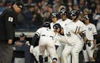 New York Yankees shortstop Didi Gregorius was congratulated by New York Yankees catcher Gary Sanchez (24) after he knocked a grand slam home run in th