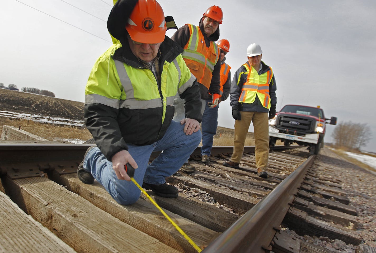 Jim Brandt, left, along with Terry Resick of Twin Cities & Western Railroad, Bob Wagner, and Dave Christianson, center, measured train tracks near Arlington, MN, Wednesday, March 26, 2014. ] (ELIZABETH FLORES/STAR TRIBUNE) ELIZABETH FLORES &#x2022; eflores@startribune.com