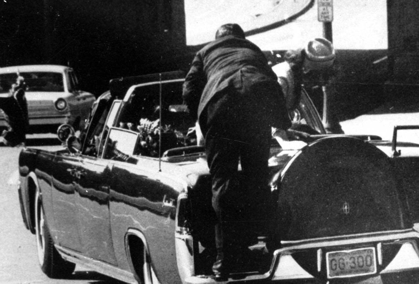 FILE -- President John F. Kennedy slumped down in back seat of car after being fatally shot in Dallas in this Nov. 22, 1963 file photo. Jacqueline Kennedy leans over president as a Secret Service agent stands on the bumper. Perhaps the most profoundly disturbing 26 seconds of footage in American history -- the Zapruder film of President Kennedy's assassination --goes on sale to the general public at video stores Monday. (AP Photo/Ike Altgens) ORG XMIT: MIN2013111114255350