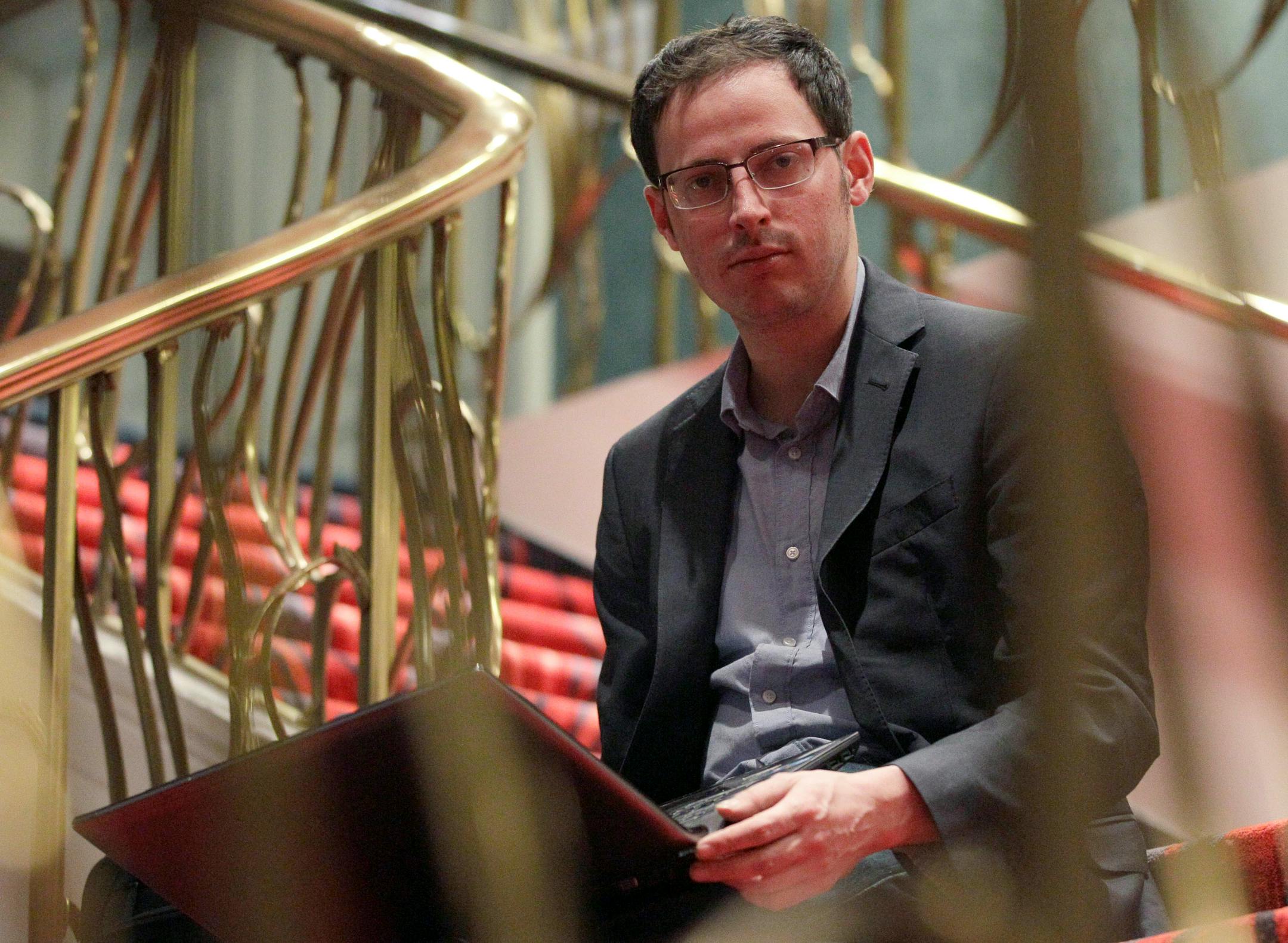 Nate Silver sits on the stairs at Allegro hotel in downtown Chicago, Friday, Nov. 9, 2012. The 34-year-old statistician, unabashed numbers geek, author and creator of the much-read FiveThirtyEight blog at The New York Times, correctly predicted the presidential winner in all 50 states, and almost all the Senate races. (AP Photo/Nam Y. Huh)