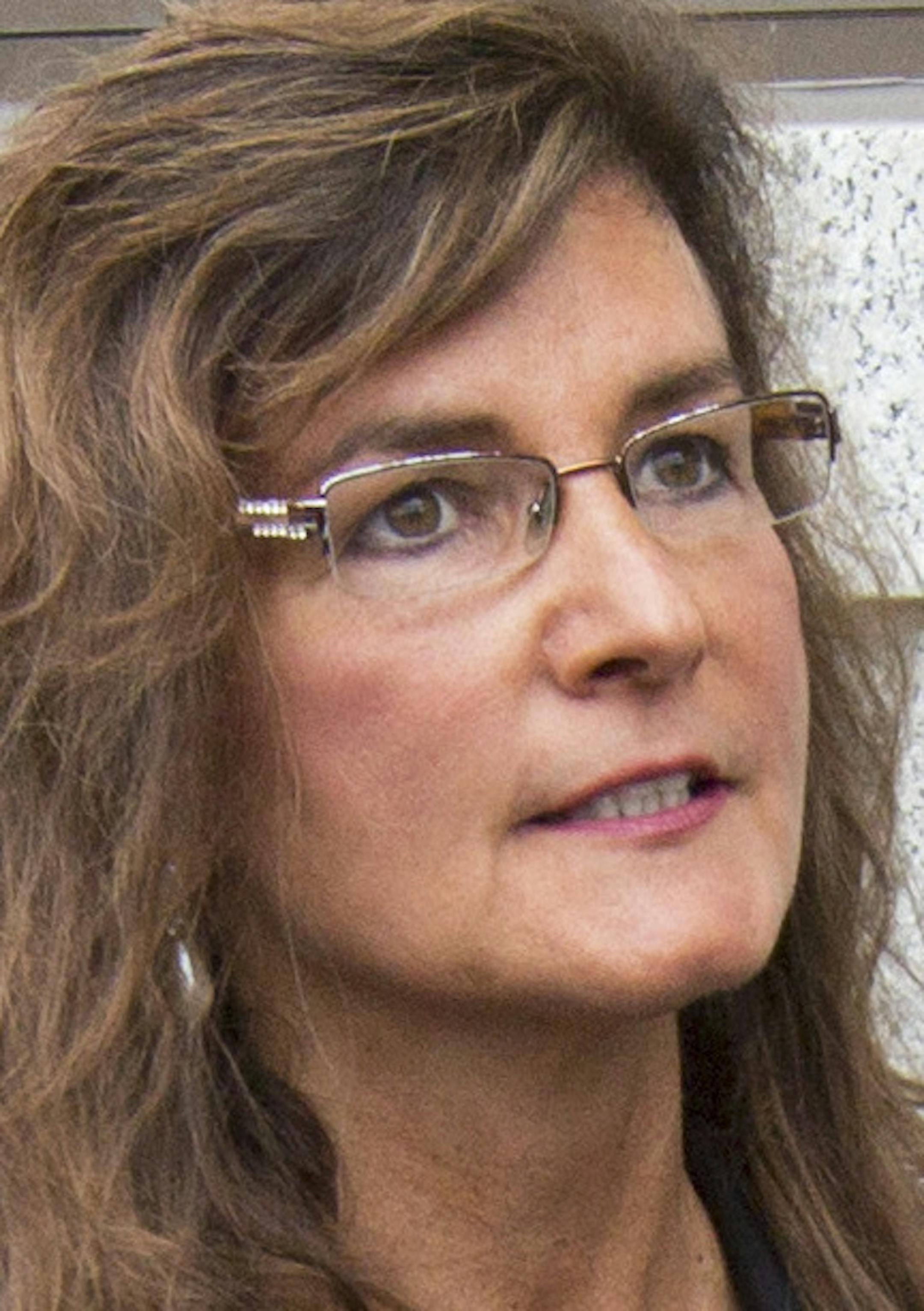 Michelle MacDonald, the Republican Party's endorsed candidate for Minnesota Supreme Court (center), announced a complaint filed against the party, Chairman Keith Downey and others, alleging they attempted to coerce her into giving up her endorsement. ] BRIAN PETERSON ‚Ä¢ brian.peterson@startribune.com St. Paul, MN 09/03/14