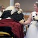 Bride Sarah Nagy, right, begins to cry as she is escorted by her father, Scott, down the aisle during her wedding ceremony Oct. 12, 2013 at First Luth