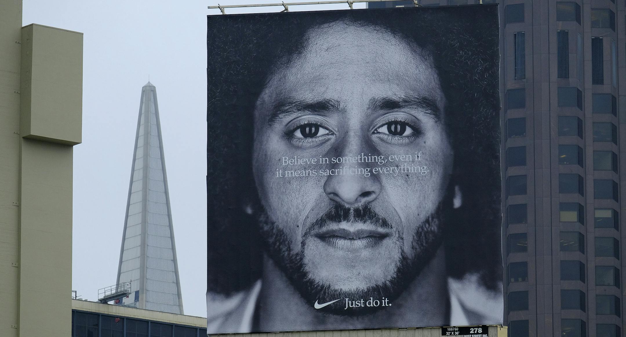 A large billboard stands on top of a Nike store showing former San Francisco 49ers quarterback Colin Kaepernick at Union Square, Wednesday, Sept. 5, 2018, in San Francisco. An endorsement deal between Nike and Colin Kaepernick prompted a flood of debate Tuesday as sports fans reacted to the apparel giant backing an athlete known mainly for starting a wave of protests among NFL players of police brutality, racial inequality and other social issues. (AP Photo/Eric Risberg)