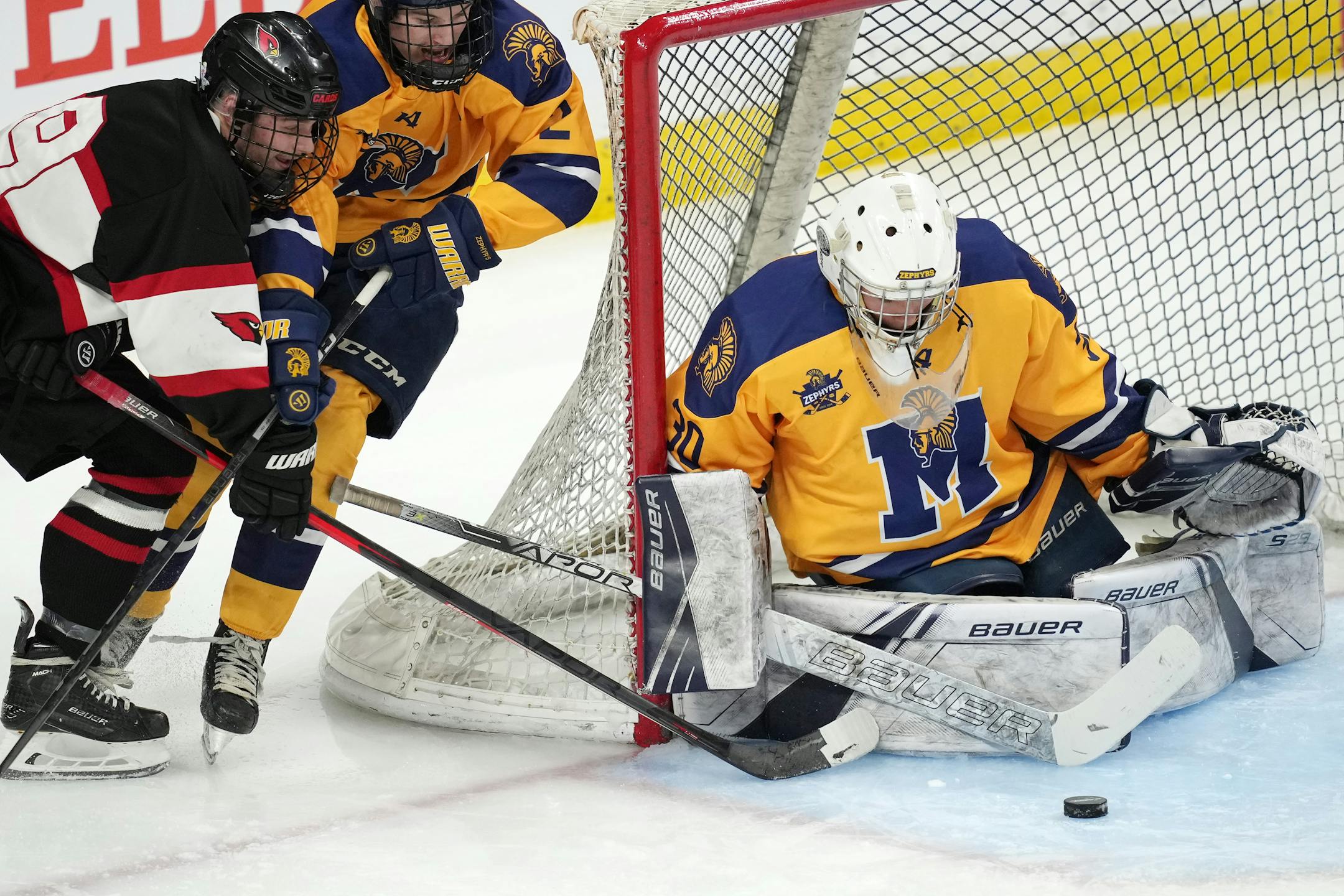 Alexandria forward Nicholas Peterson (29) tries to score on Mahtomedi goaltender Charles Brandt (30) with the wrap around shot in the second period of a MSHSL Class 1A quarterfinal hockey game between Alexandria and Mahtomedi.