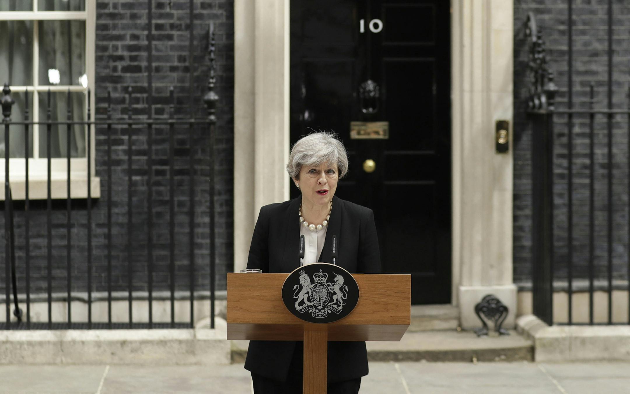 British Prime Minister Theresa May addresses the media outside 10 Downing Street, London, Tuesday May 23, 2017, the day after an apparent suicide bomber attacked an Ariana Grande concert as it ended Monday night, killing over a dozen of people among a panicked crowd of young concertgoers. (AP Photo/Matt Dunham) ORG XMIT: MIN2017052514523409