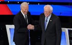 FILE -- Former Vice President Joe Biden shakes hands with Sen. Bernie Sanders (I-Vt.) during the Democratic presidential debate at Drake University in