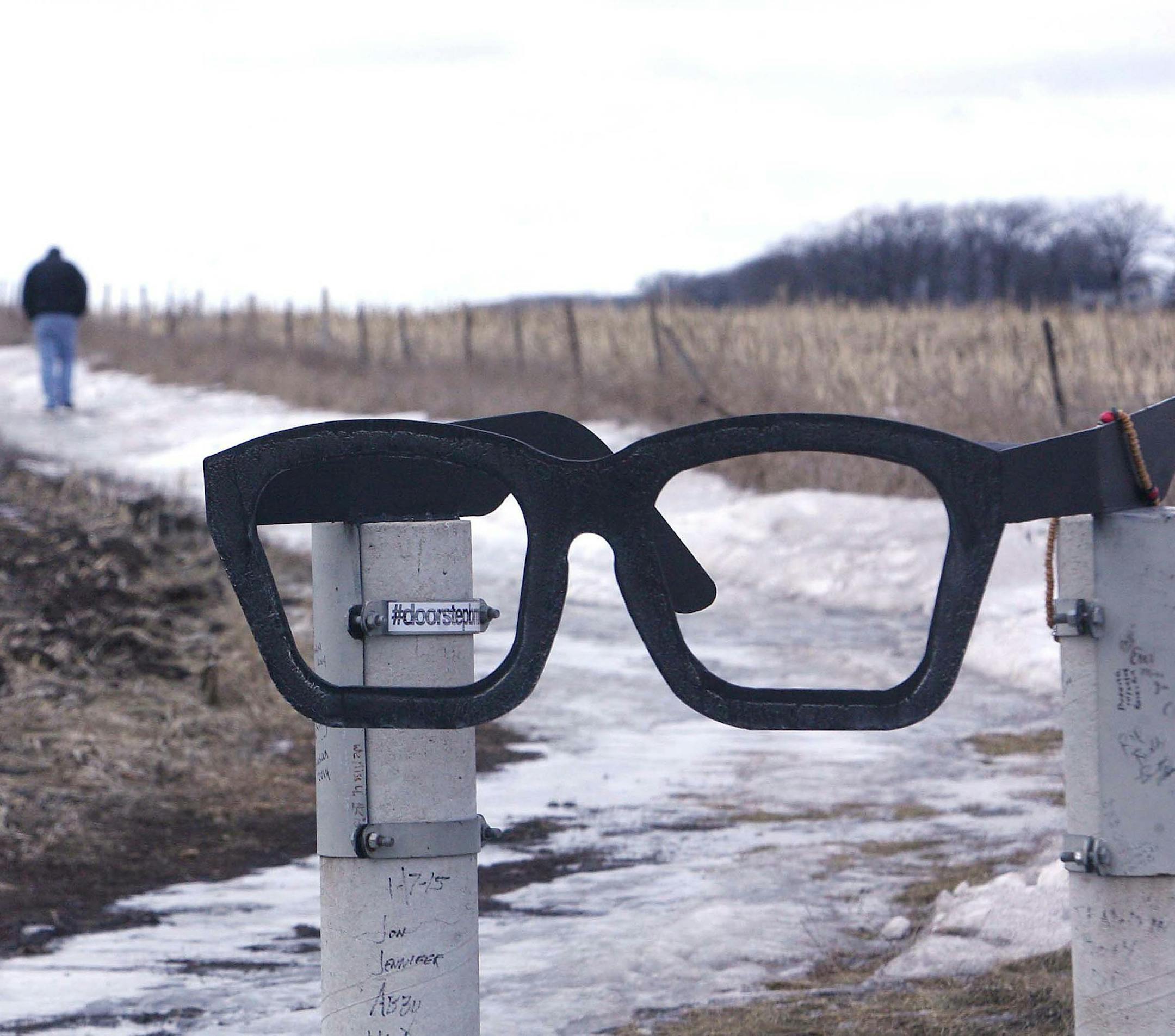 In this photo taken Thursday, Jan. 29, 2015, dedicated fans make the trek each year the visit the crash site, north of Clear Lake, Iowa, where Buddy Holly, Ritchie Valens, J.P. Richardson and pilot Roger Peterson died on Feb.3, 1959. (AP Photo/Globe Gazette, Jeff Heinz)