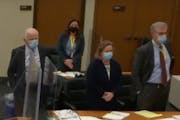 In this screen grab from video, the defense team stands at a table as potential jurors enter the courtroom during the manslaughter trial of former Bro
