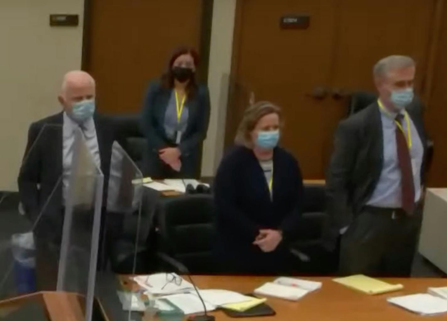 In this screen grab from video, the defense team stands at a table as potential jurors enter the courtroom during the manslaughter trial of former Brooklyn Center police officer Kimberly Potter in the shooting death of Daunte Wright during jury selection Friday, Dec. 3, 2021 at the Hennepin County Courthouse in Minneapolis, Minn. (Court TV, Pool) ]