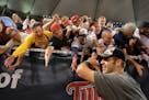 Joe Mauer celebrates with fans after winning the division in extra innings.