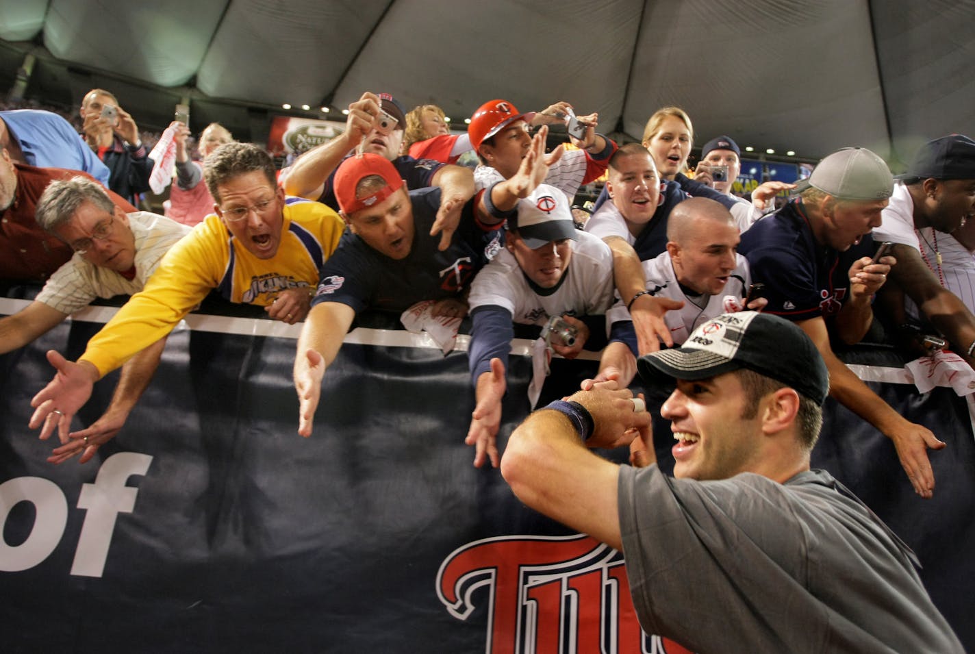 Joe Mauer celebrates with fans after winning the division in extra innings.