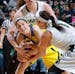 Michigan's Katelynn Flaherty, left, and Michigan State's Tori Jankoska (1) wrestle for the ball during the second half of an NCAA college basketball g