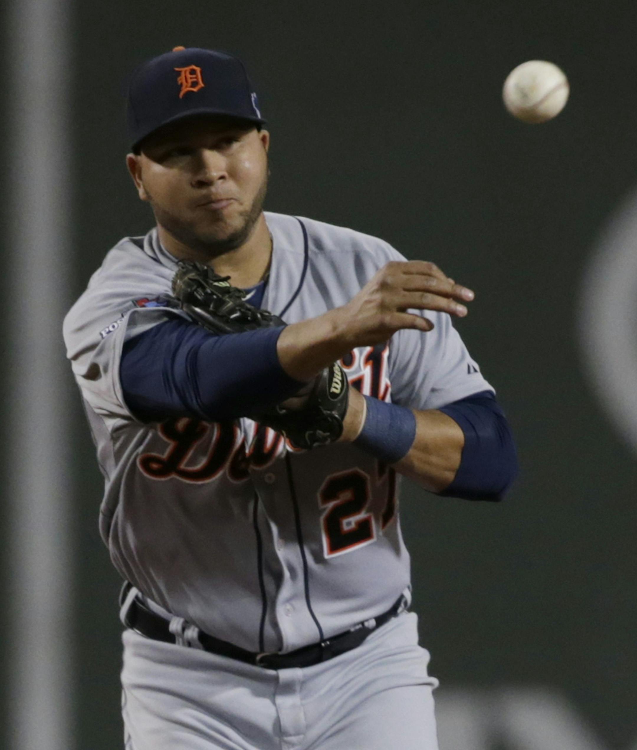 Detroit Tigers shortstop Jhonny Peralta (27) throws out Boston Red Sox left fielder Mike Carp at first base to turn a double play in the fourth inning taking Boston Red Sox's David Ortiz (34) out at second base during Game 2 of the American League baseball championship series Sunday, Oct. 13, 2013, in Boston. (AP Photo/Charles Krupa) ORG XMIT: MIN2013110618473482