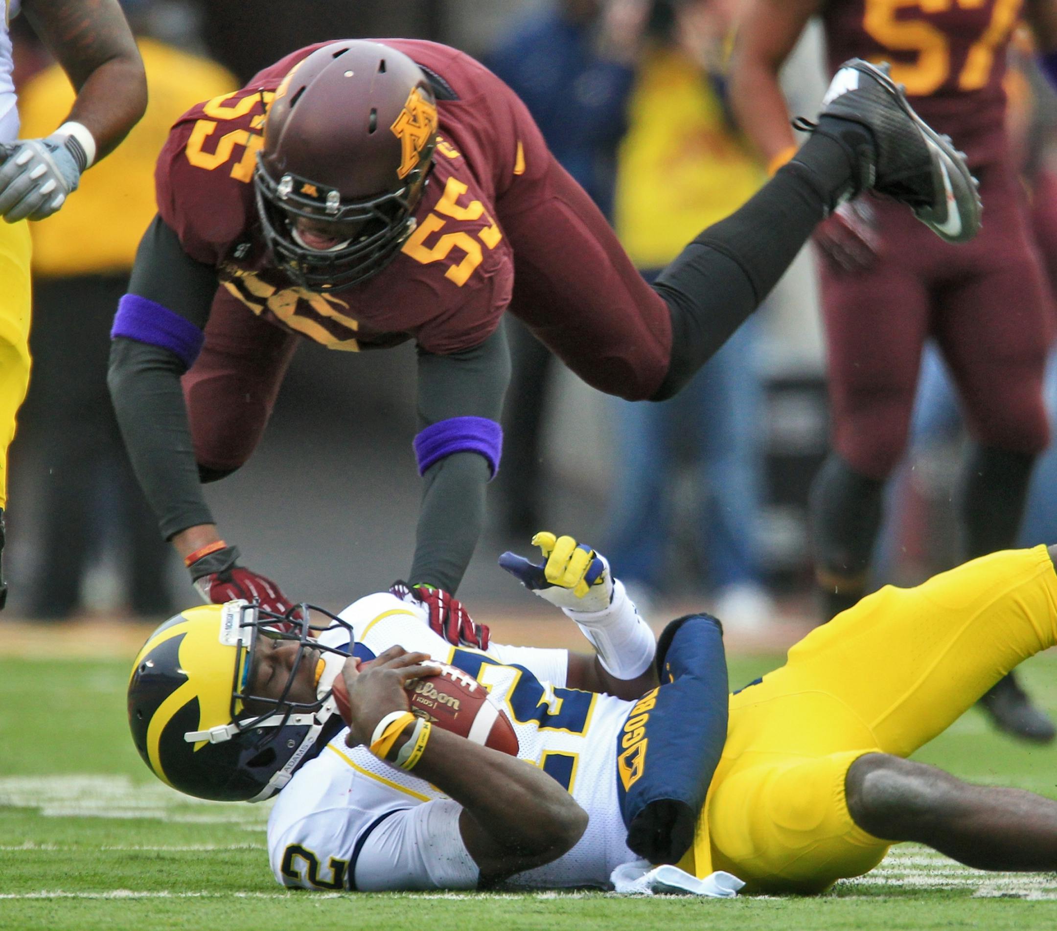 The Gophers' Theiren Cockran (55) sacked Michigan quarterback Devin Gardner during the Wolverines' 35-13 victory Saturday.