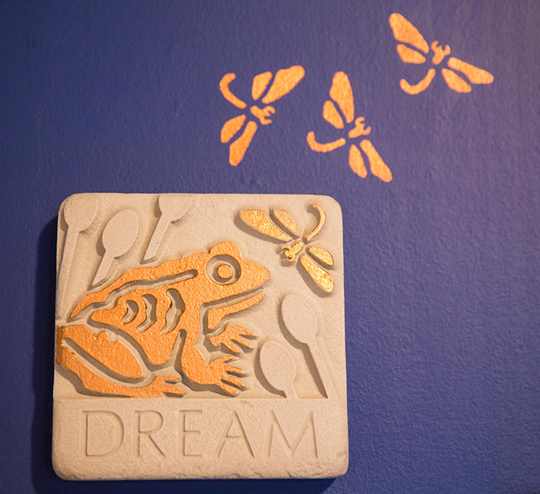 A decorative tile invite visitors to "Dream."