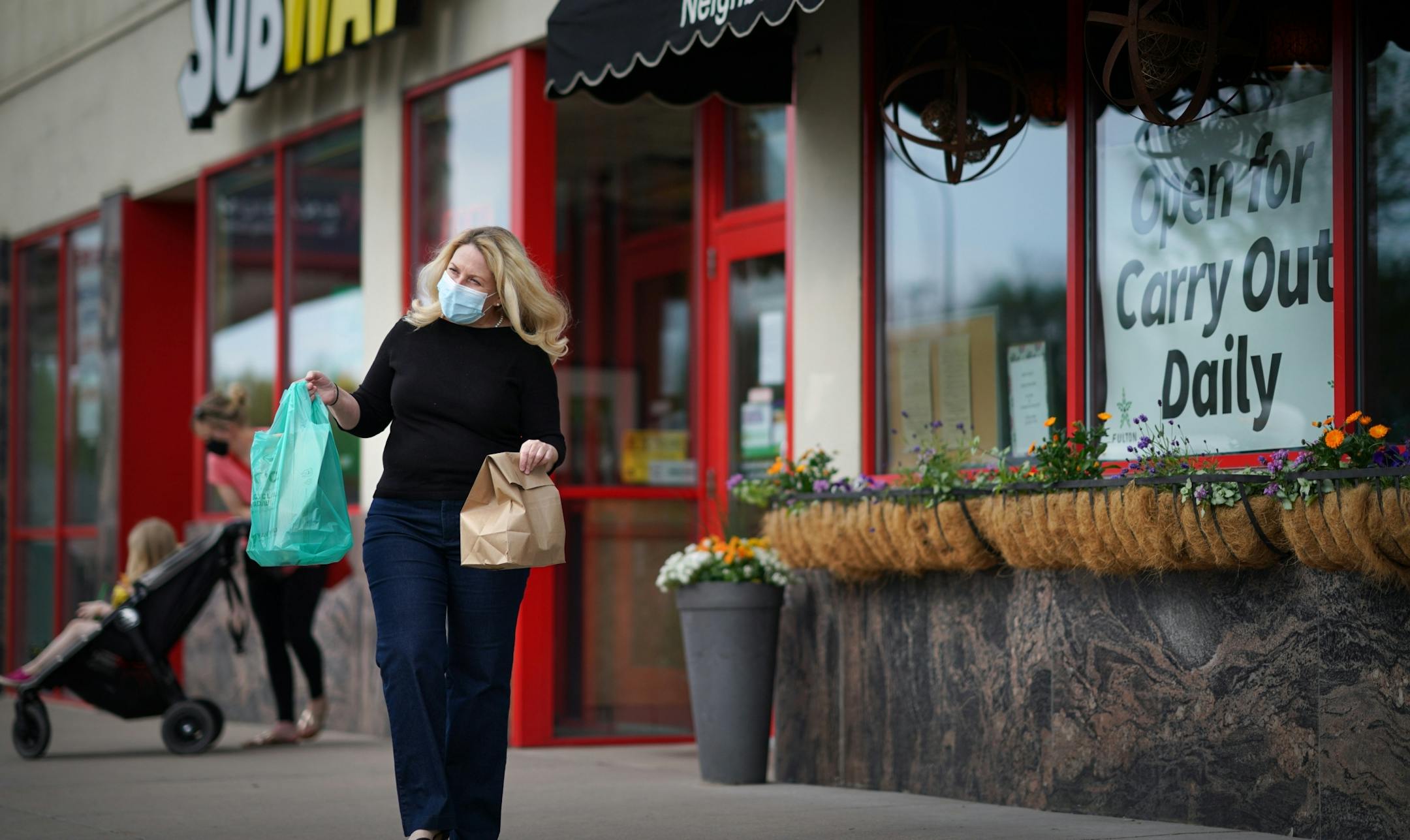 Jennifer King, owner of Prima, kept an eye on the food delivery parking spots in front of her restaurant on Lyndale Ave and she delivered their orders. In between deliveries, she checked for incoming orders on her phone.