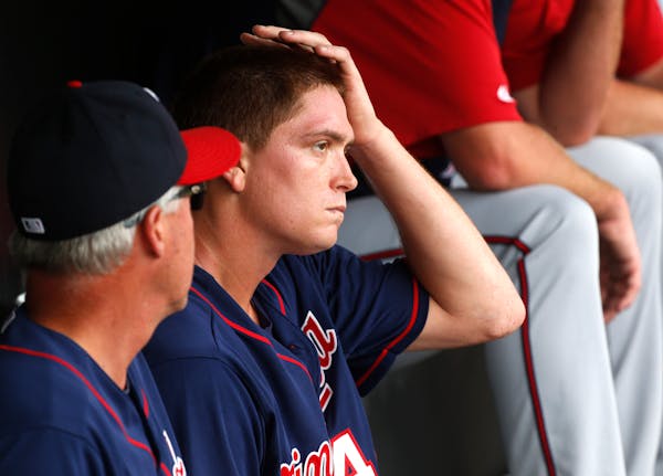 Minnesota Twins starting pitcher Kyle Gibson, right, listens to pitching coach Rick Anderson in the dugout after Gibson was pulled from the game durin