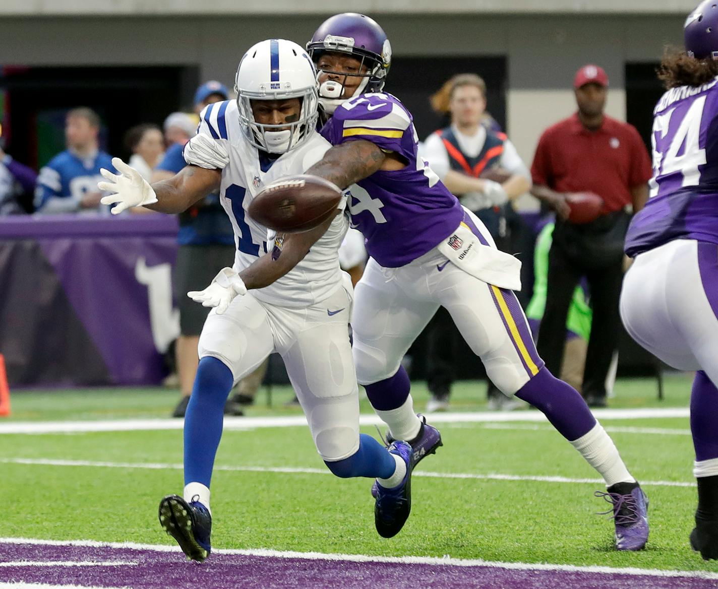 Indianapolis Colts wide receiver T.Y. Hilton, left, reaches for an incomplete pass as Minnesota Vikings cornerback Captain Munnerlyn defends during the first half of an NFL football game Sunday, Dec. 18, 2016, in Minneapolis. (AP Photo/Charlie Neibergall)