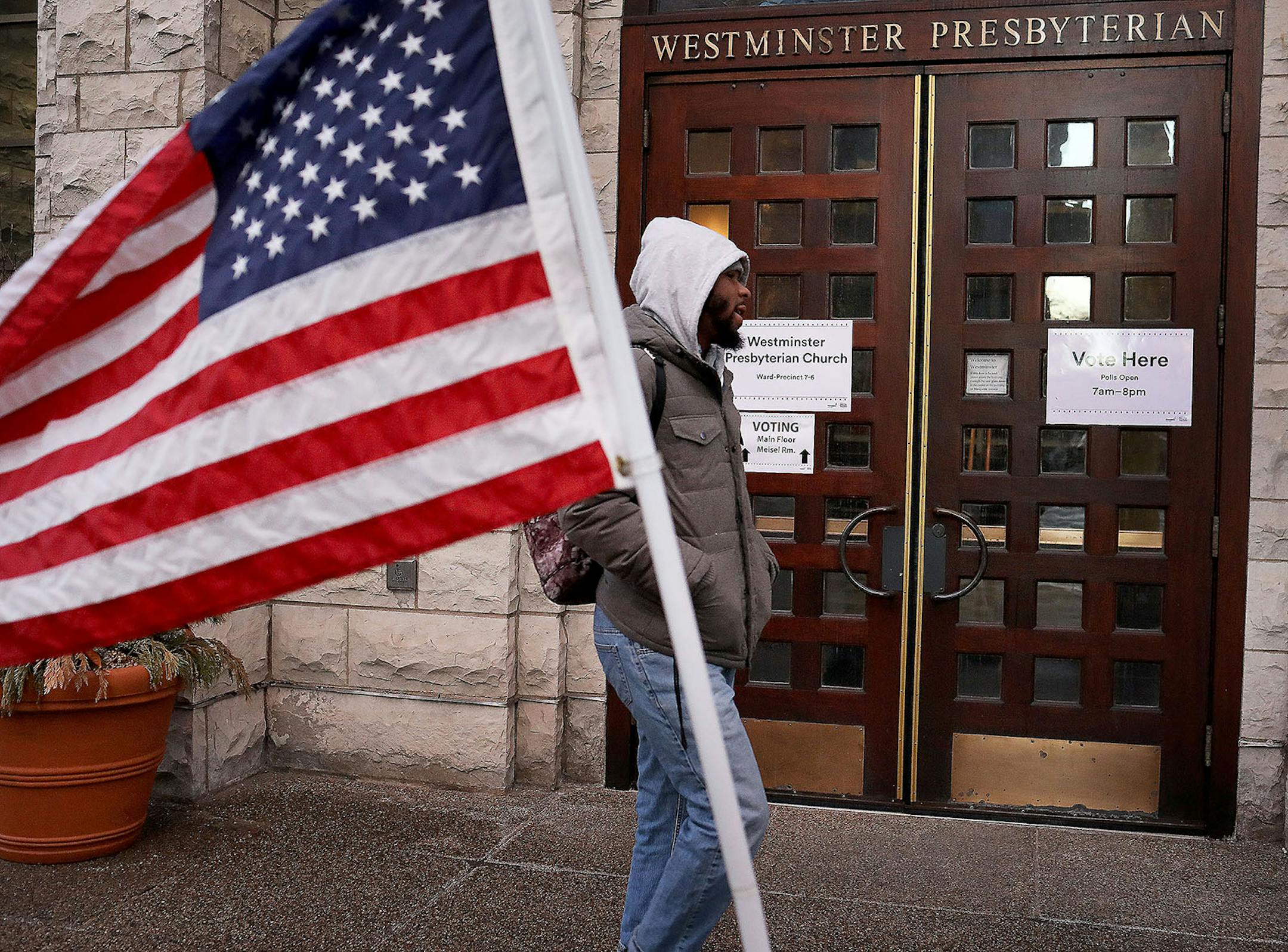 A pedestrian walked past the polling place at Westminster Presbyterian Church in downtown Minneapolis before the polls opened for Super Tuesday's presidential primary.