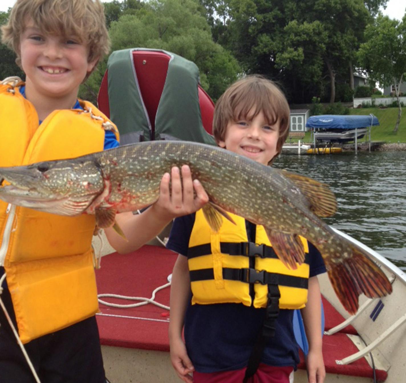 A GREAT DAY Turner Koltnow, 8, (left) and his brother, Max, 6, of Eden Prairie proudly held a 28-inch northern Max caught on a local lake while fishing with their grandpa, Dennis Koltnow. "Max handled the fish well and declared it to be 'the lake's largest northern by far,''' said Dennis Koltnow. "A great day for the boys and an even better one for gramps.''