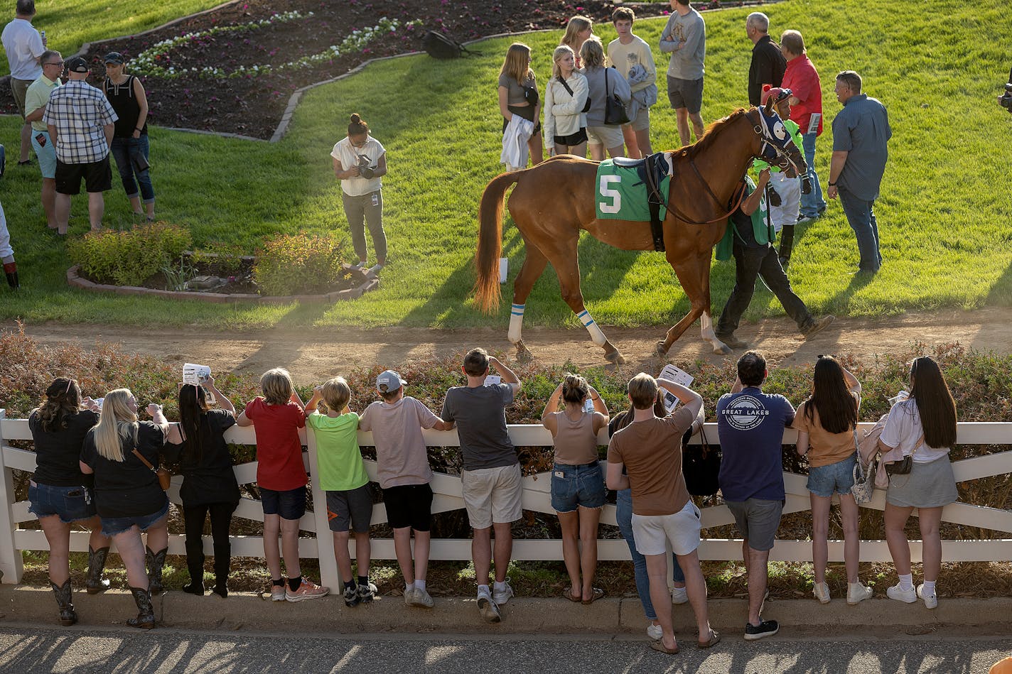 Race fans get a view of the horses in the paddock before a race on opening night at Canterbury Park on May 27