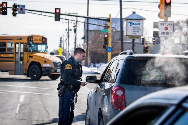 St. Paul Police motor officer John Conrad gives a ticket for speeding to a driver he pulled over on Dale Street.