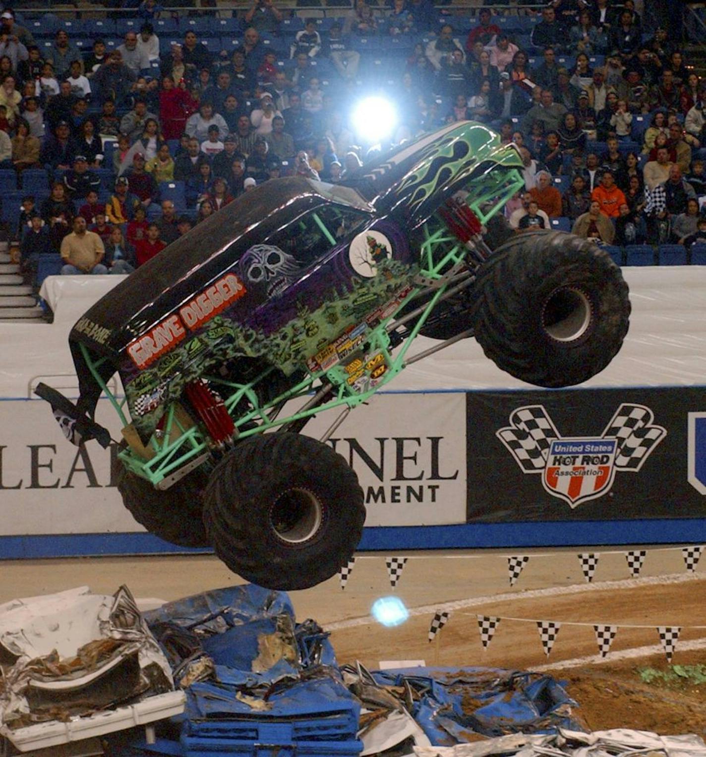 Pablo Huffaker pilots Grave Digger over cars during the U.S. Hot Rod Association's Monster Jam Sunday Jan. 23, 2005 at the Alamodome in San Antonio, Tx. PHOTO BY