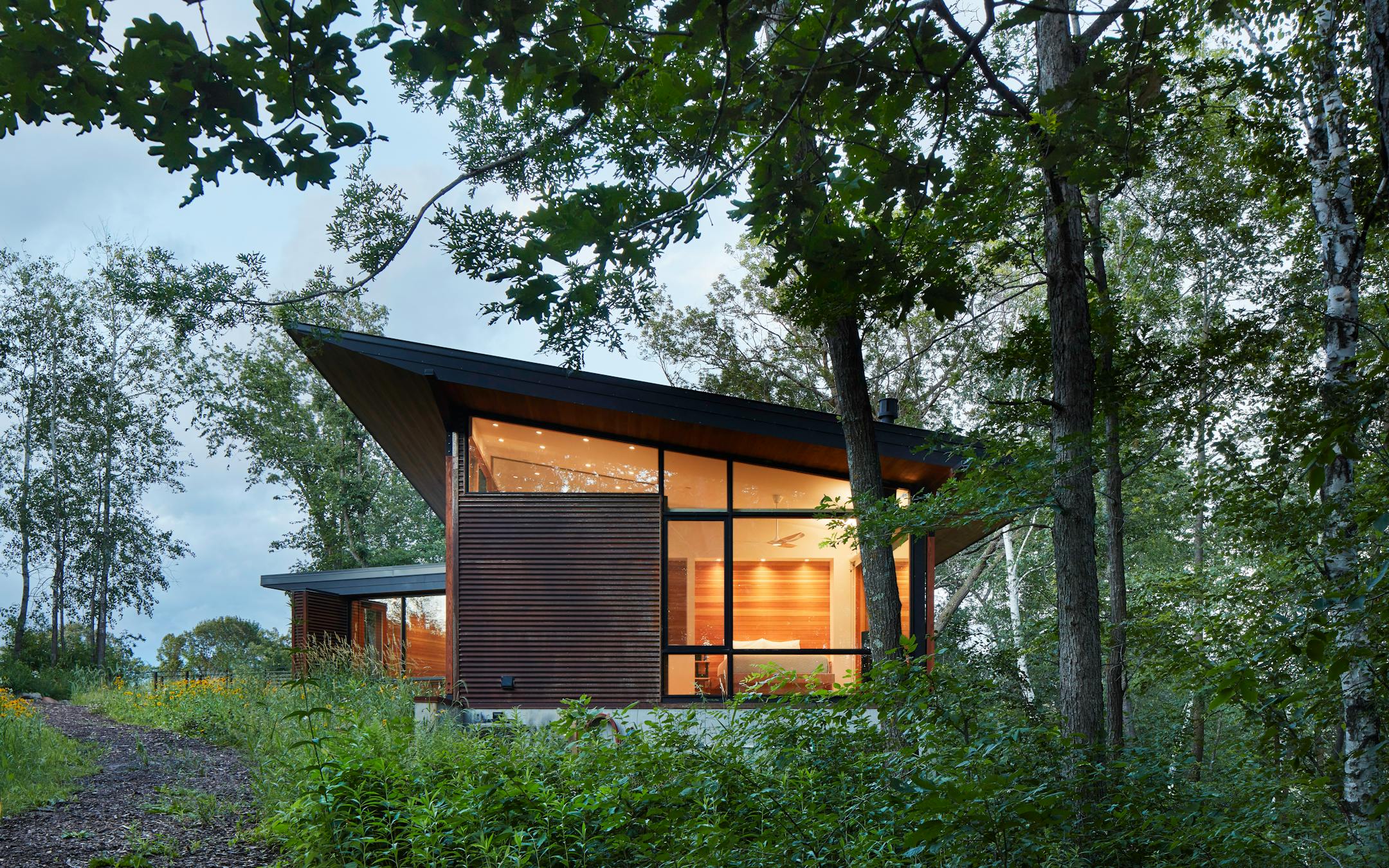 Set against a backdrop of rolling hills and prairie, SALA Architect's Home of the Month winning retreat is an restorative getaway in Frederic, Wis. that also restores the land.