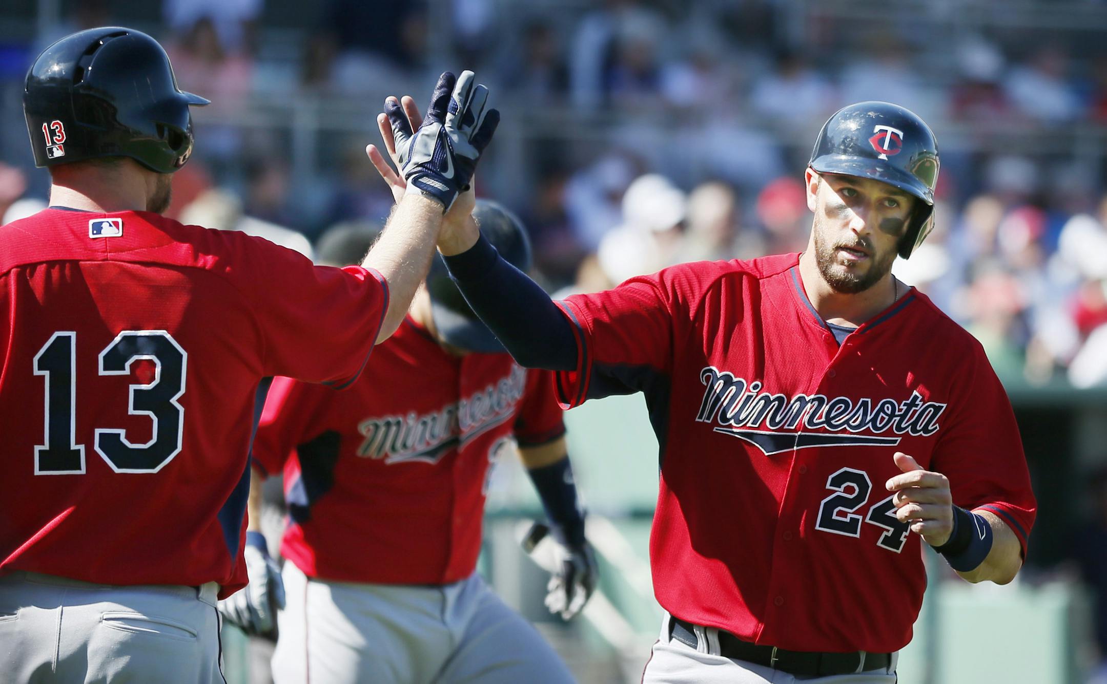 Twins third baseman Trevor Plouffe high fived Jason Kubel affter he scored in the forth inning on a hit by Oswaldo Aricia . The Boston Red Sox hosted the Minnesota Twins in the both team's fist spring training game Friday Feb 28. 2014 in Fort Myers, Florida at Jet Blue Park .Twins beat Boston 8-2. ] JERRY HOLT jerry.holt@startribune.com Jerry Holt