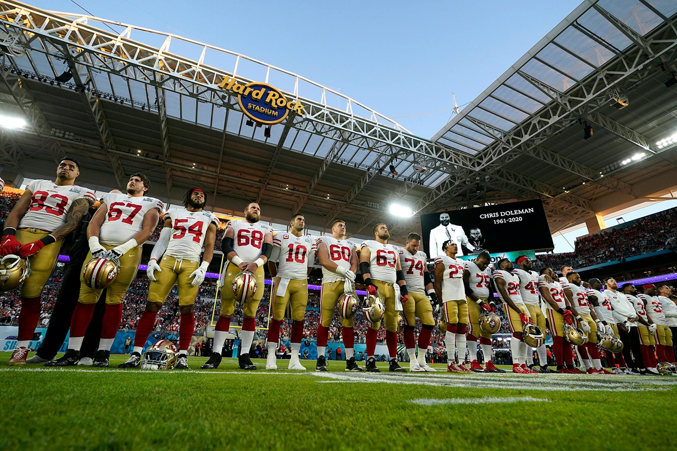 San Francisco 49ers players stand for a moment of remembrance before the NFL Super Bowl 54 football game against the Kansas City Chiefs Sunday, Feb. 2, 2020, in Miami Gardens, Fla.