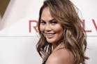 Chrissy Teigen poses at the 2017 Revolve Awards at the Dream Hollywood hotel on Thursday, Nov. 2, 2017, in Los Angeles.