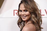 Chrissy Teigen poses at the 2017 Revolve Awards at the Dream Hollywood hotel on Thursday, Nov. 2, 2017, in Los Angeles.