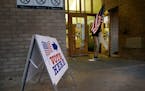 As the polls were about to open for the day at the Brian Coyle Center in Minneapolis on Nov. 7, an election worker walked to place a flag outside the 