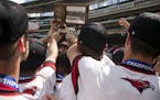 Minnehaha Academy reaches for their trophy after winning the 2017 Class 2A State Tournament Championship Game against Pierz at Target Field in Minneap