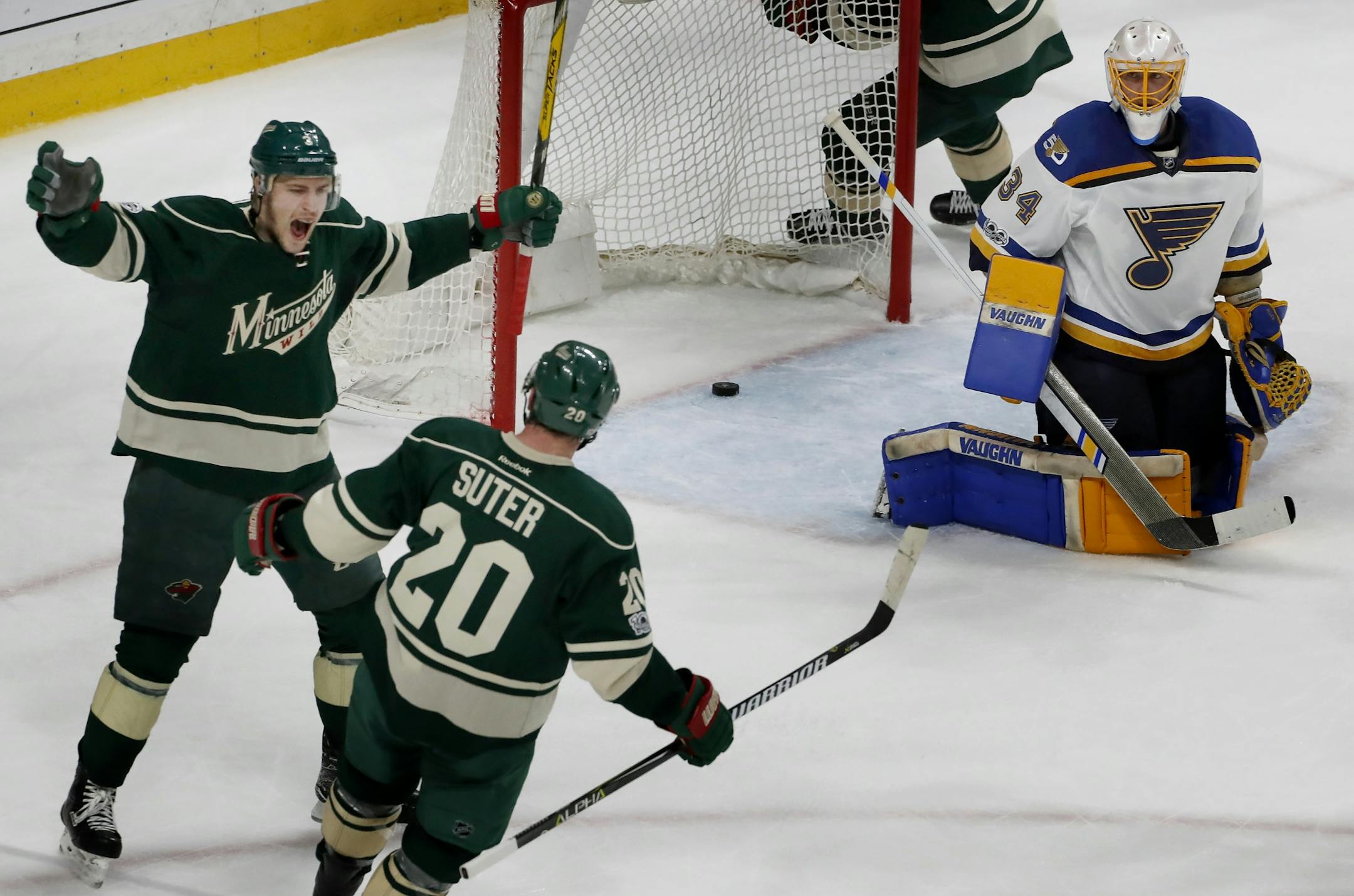 Ryan Suter (20) and Charlie Coyle (3) celebrated a Suter power play goal in the first period.