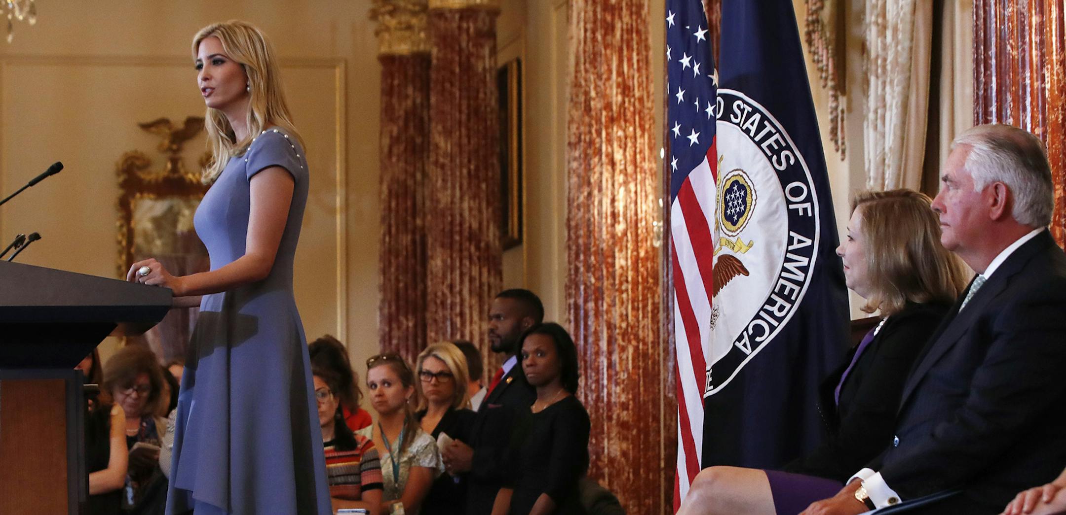 Ivanka Trump, left, speaks at the State Department in Washington, Tuesday, June 27, 2017, during the release of the 2017 Trafficking in Persons Report. Ambassador-at-Large to Monitor and Combat Trafficking in Persons and Senior Advisor to the Secretary of State Susan Coppedge, center, Secretary of State Rex Tillerson, and others, listen. (AP Photo/Jacquelyn Martin) ORG XMIT: MIN2017063011450711