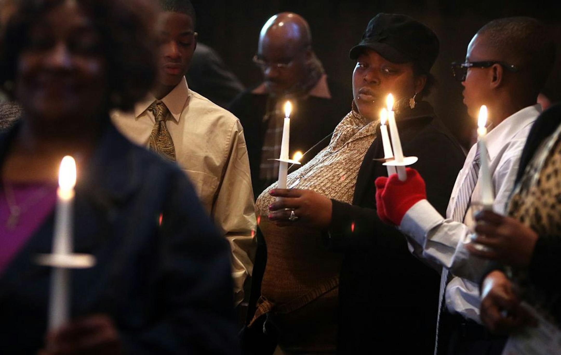 Marsha Mayes held a candle during the memorial service as the names of loved ones who had been lost to violence were read. Three-year-old Terrell Mayes, was killed a year ago, on Dec. 26, 2012.